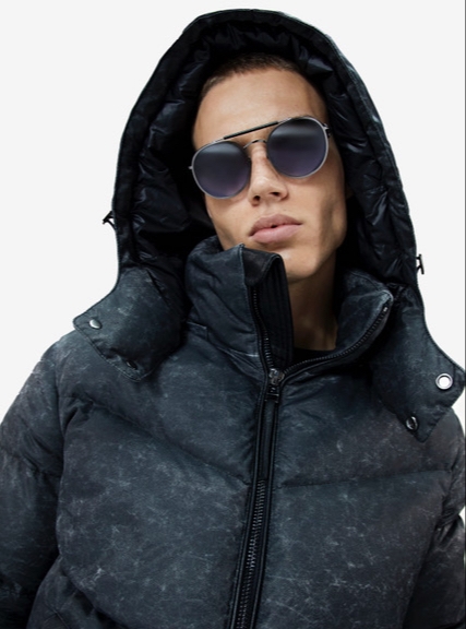Man in sunglasses wears Boda Skins coat with hood up