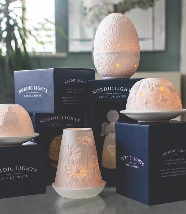 group of white dome tealight holders on a display with boxes