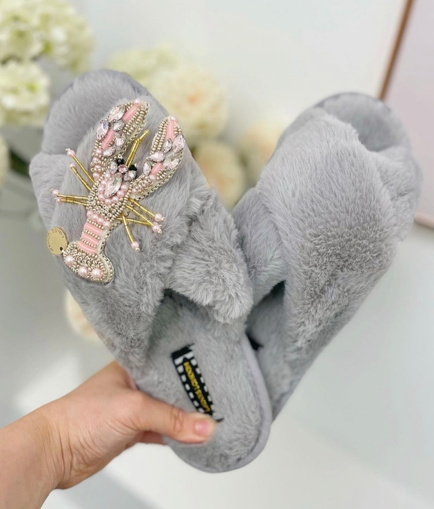 grey fluffy cross slippers with pink jewelled lobster attached