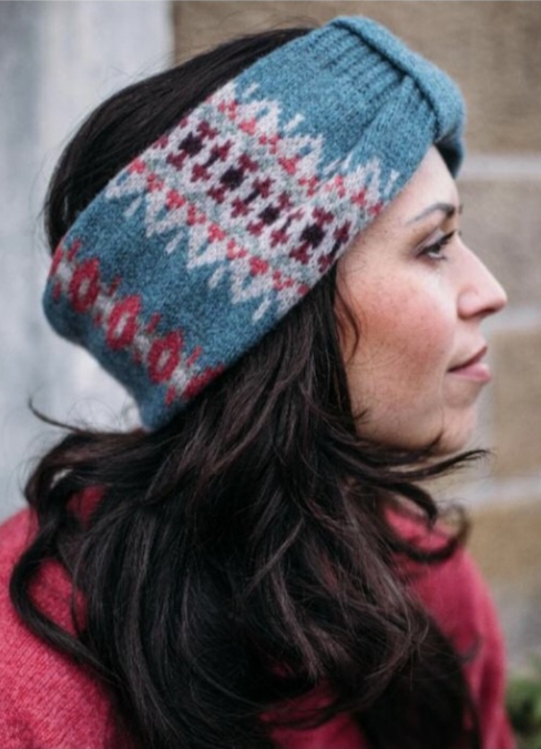 brunette woman in a blue knitted head warmer