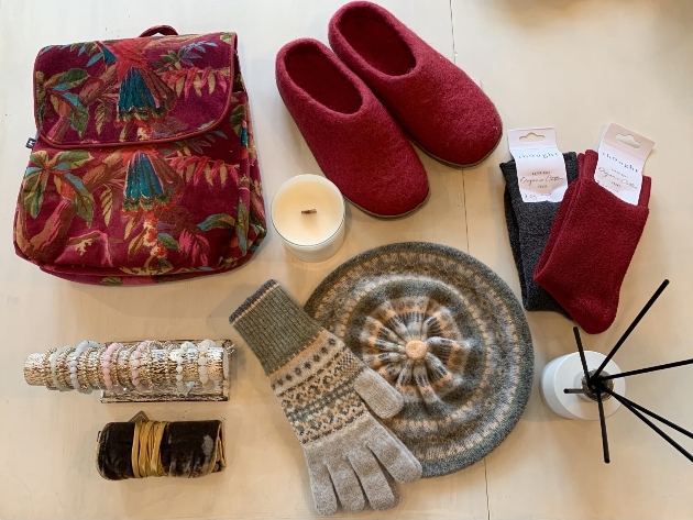 shoes, hats, candles, bag, socks on a table