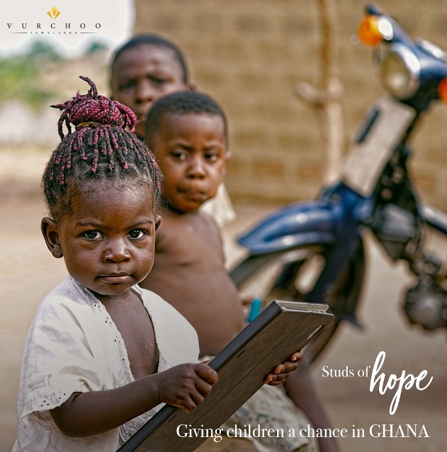 Ghana toddler holding a book