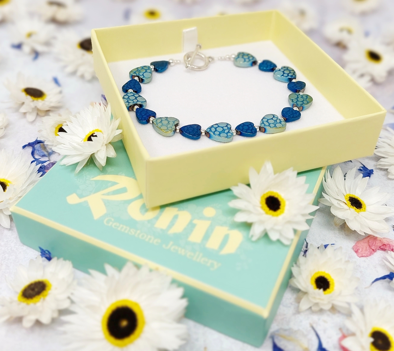 blue heart and silver bracelet in yellow gift box