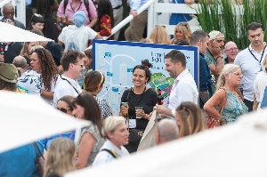 visitors enjoying drinks outside at trade show