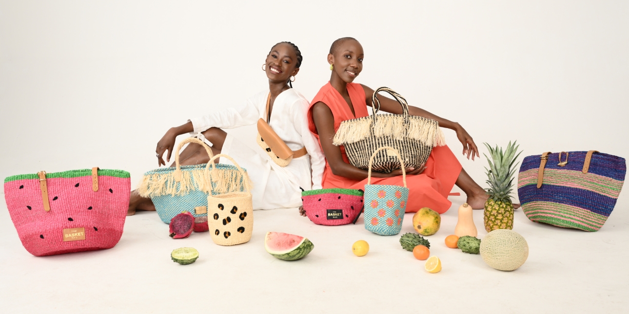 two models sat on floor surrounded by lots of bags