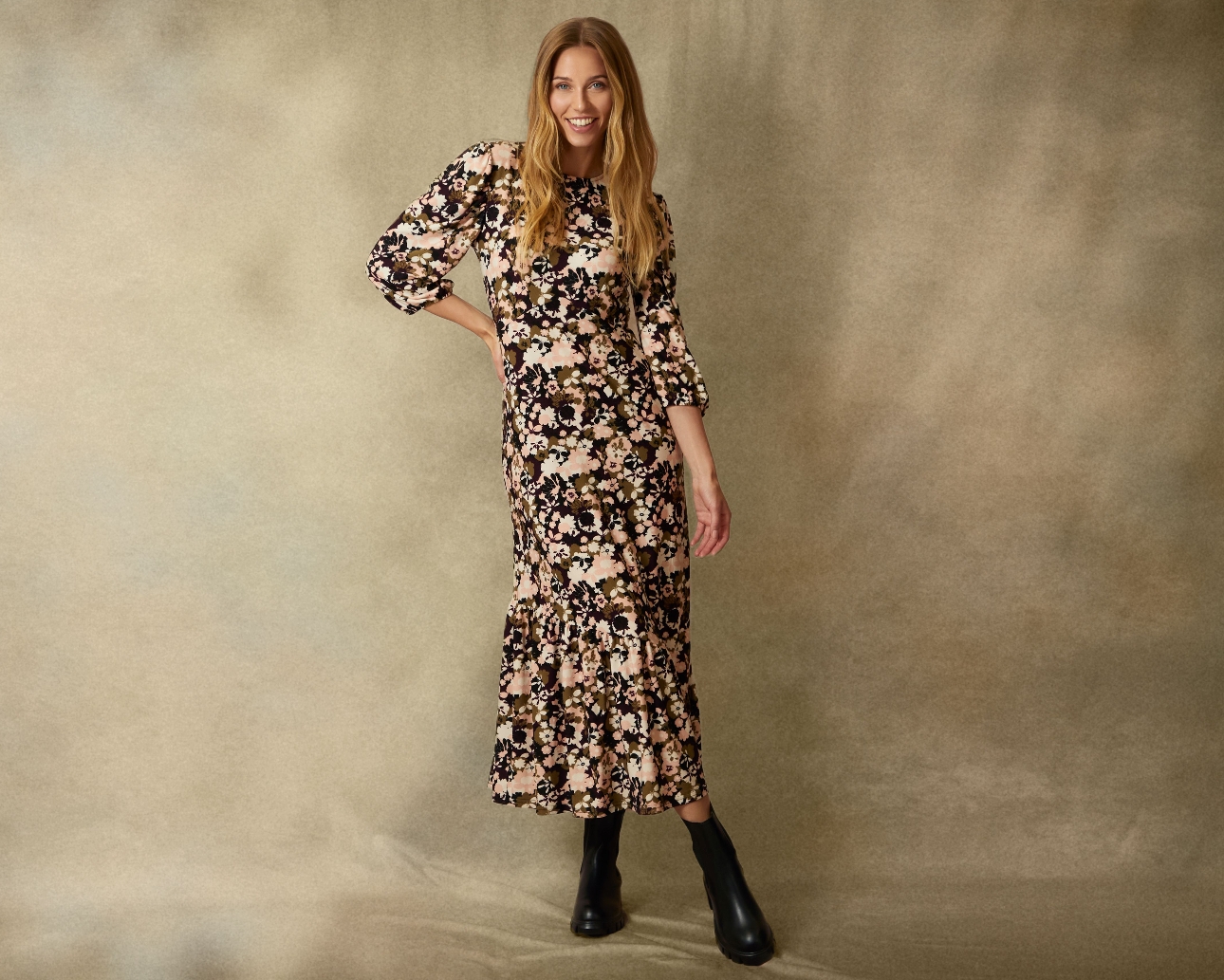 woman in floral dress long sleeves and black boots