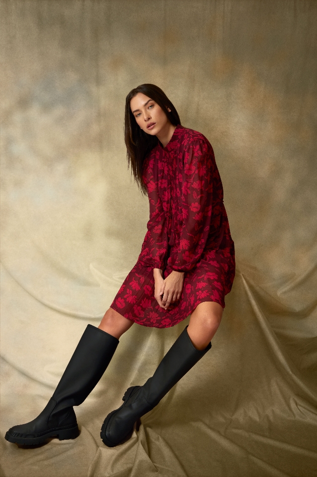 model in red floral dress, knee length red flower print knee high biker boots 