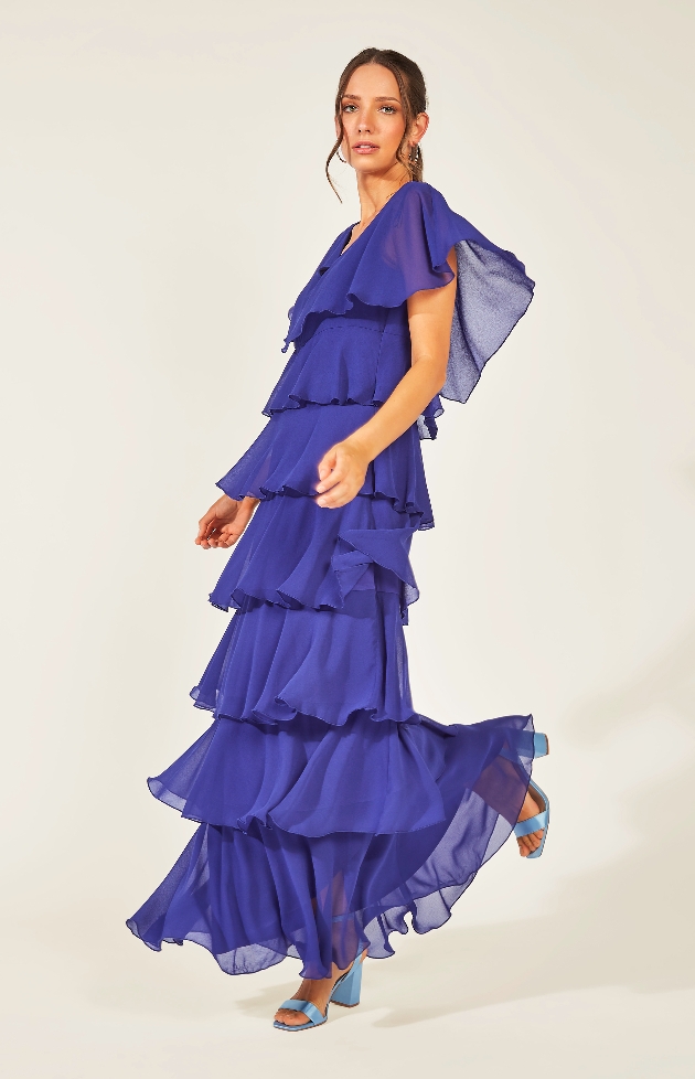 purple tiered dress model wearing blue shoes with it 