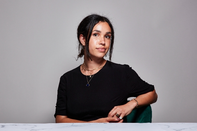 woman in black top sat at table