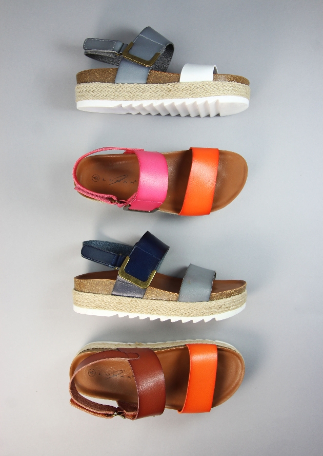 four coloured sandals lined up in a row