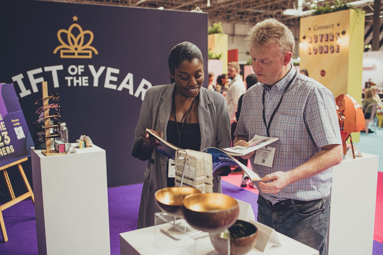two people standing at gift of the year stand