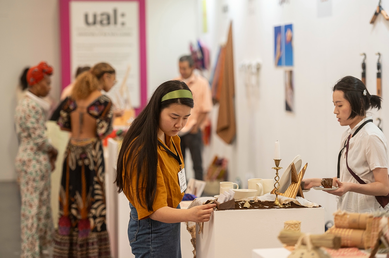 woman at stand looking at jewellery 