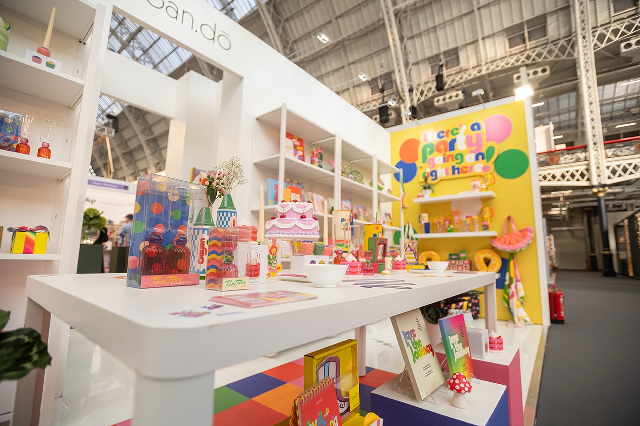 colourful stand at show with banners and products on shelves