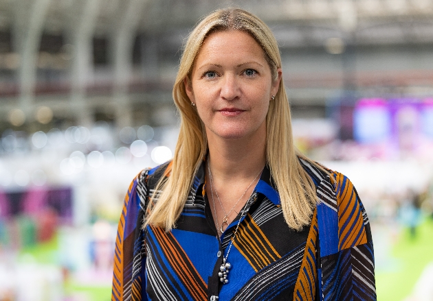 lady looking at camera wearing blue and orange shirt