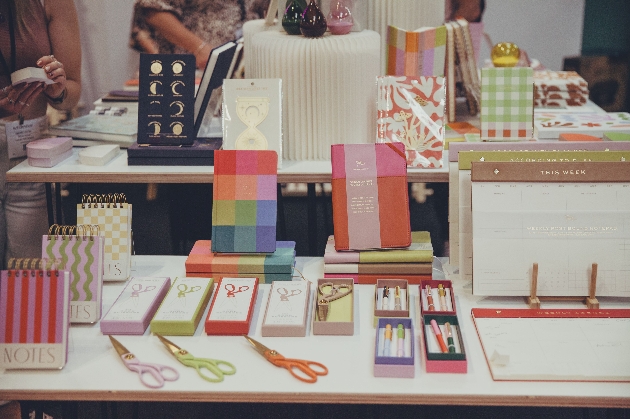bright notebooks and scissors on a display stand