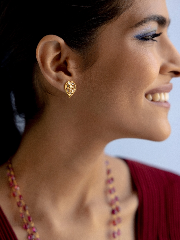 model wearing small gold earring