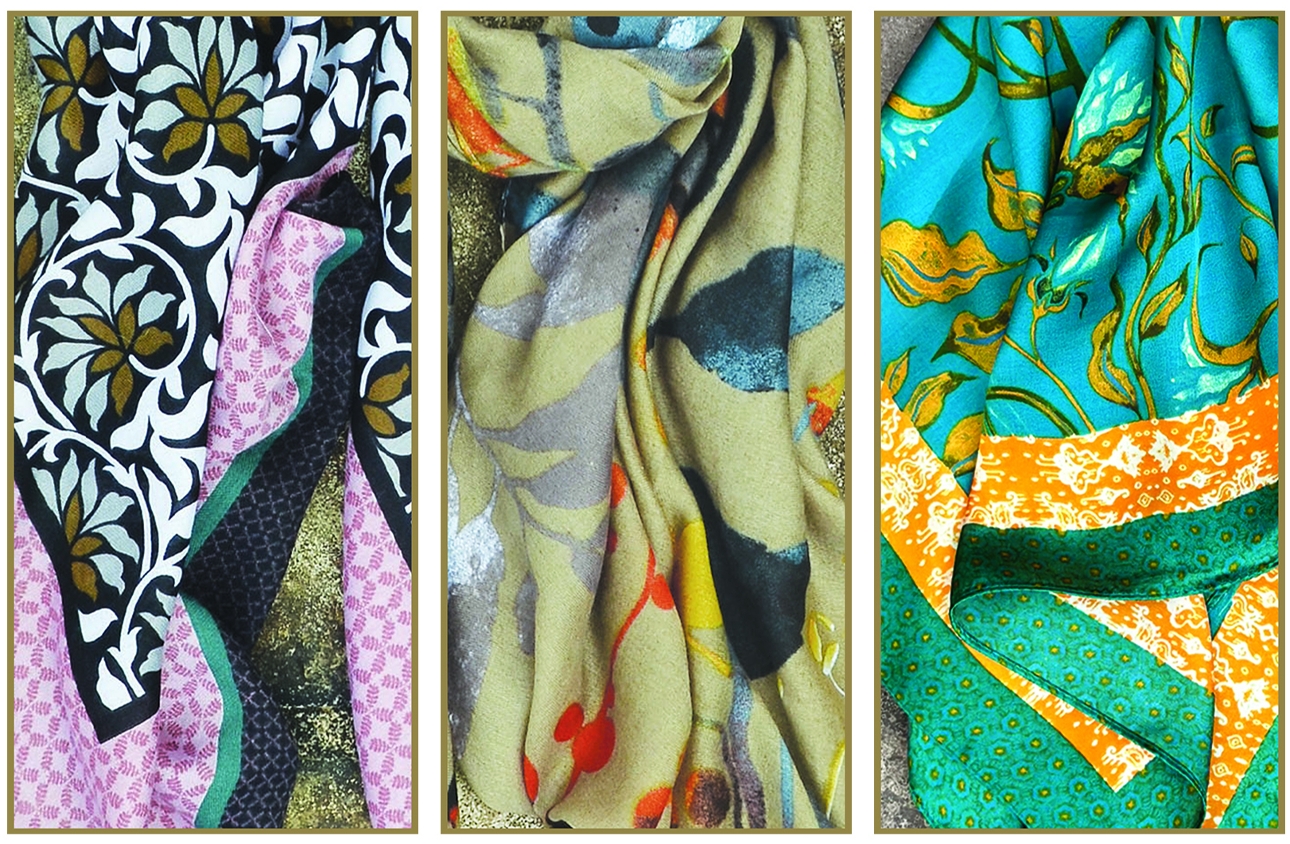 three different coloured and printed scarves