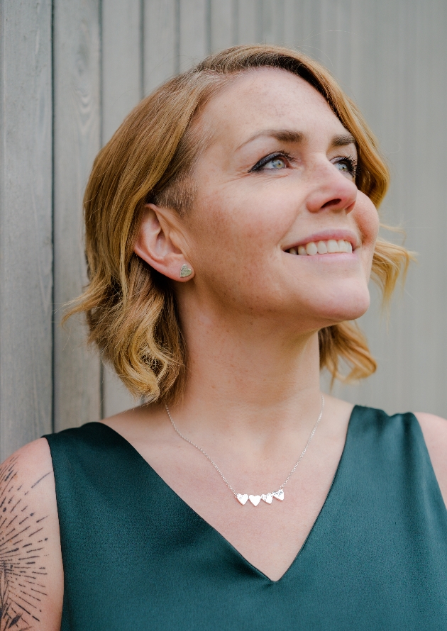 woman in silver jewellery, heart necklace and earrings