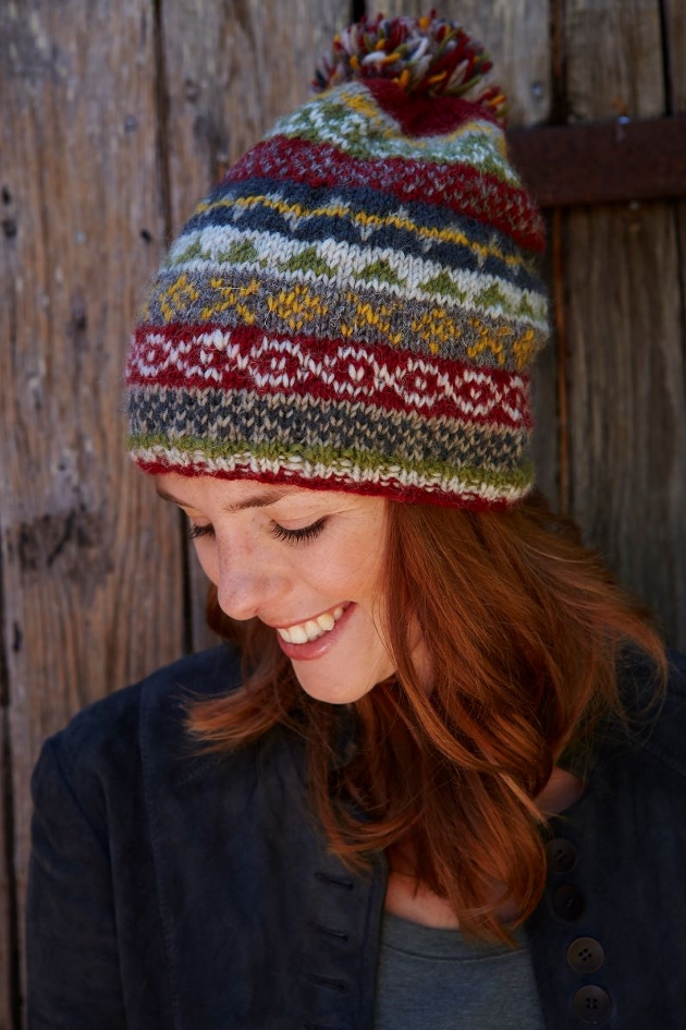 woman in bobble hat with earthy tones