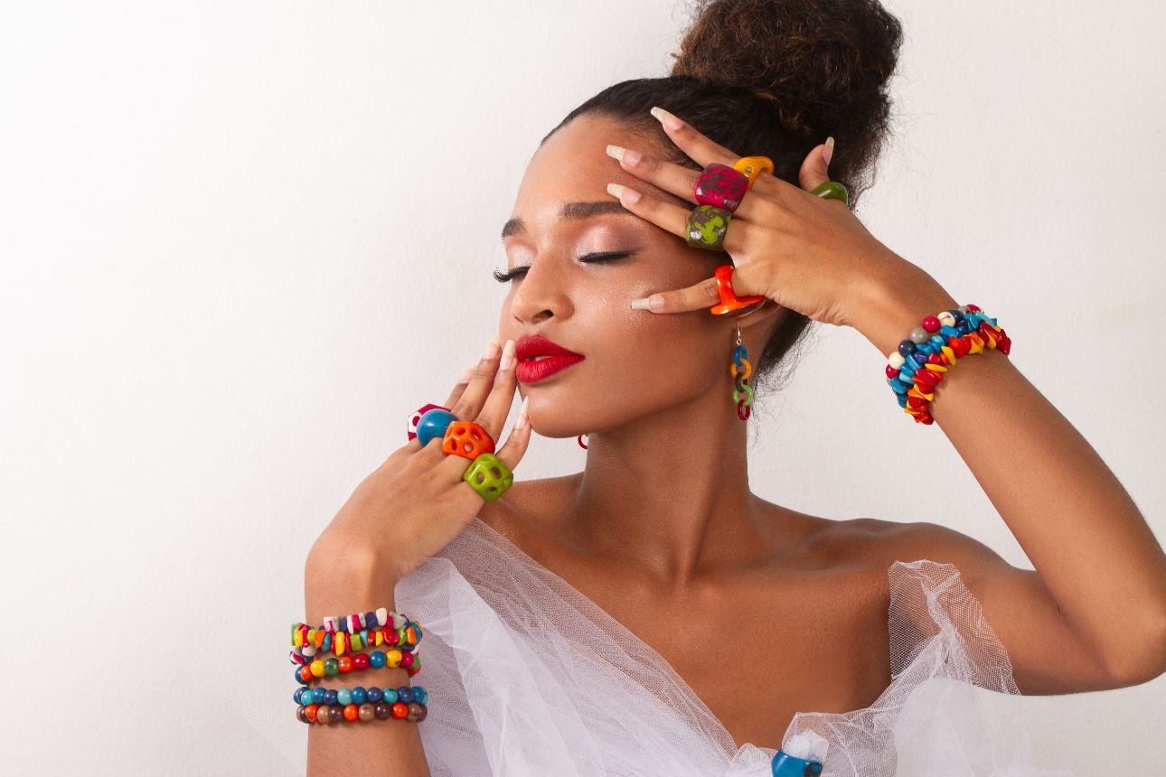 model in bright chunky jewellery earrings rings and bracelets 