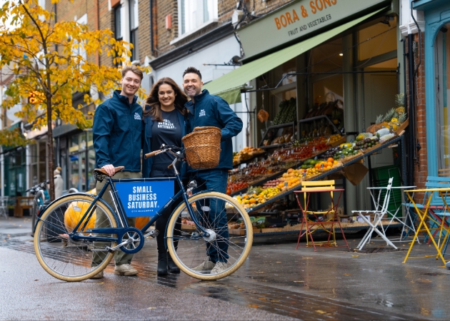 three people in front of bicycle